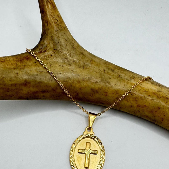 shimmering gold diamond cut cross amulet about half inch long 
Comes on a choice of chain lengths